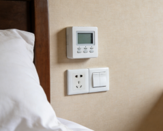 Can a wired control box for underfloor heating be installed in a bathroom?